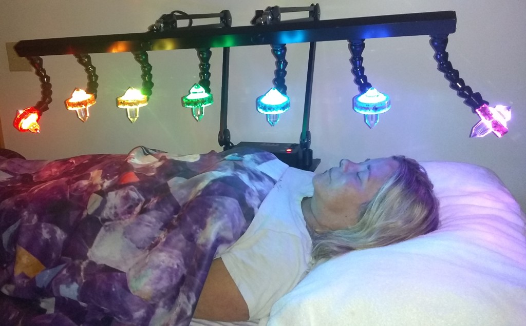 Guest enjoying the Crystal Healing Bed service at AGLOW Crystal Healing Wellness Center